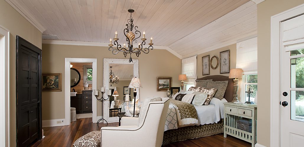 Master bedroom with a vaulted plank ceiling, chandelier and hardwood floors