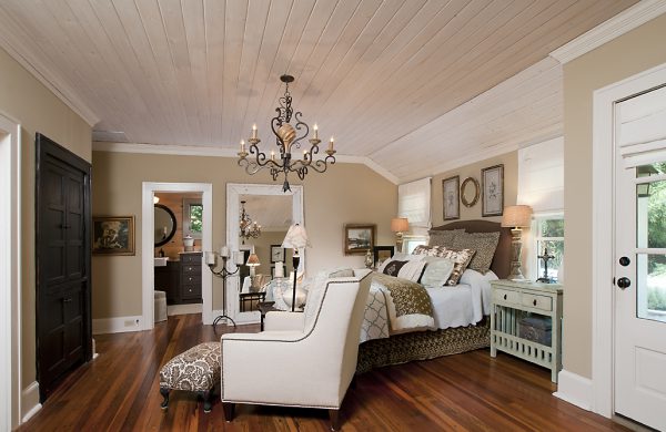 Master bedroom with a vaulted plank ceiling, chandelier and hardwood floors