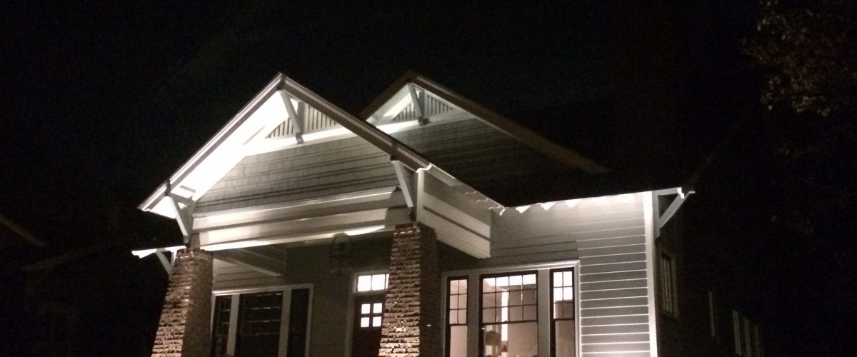 Craftsman custom home exterior illuminated at night